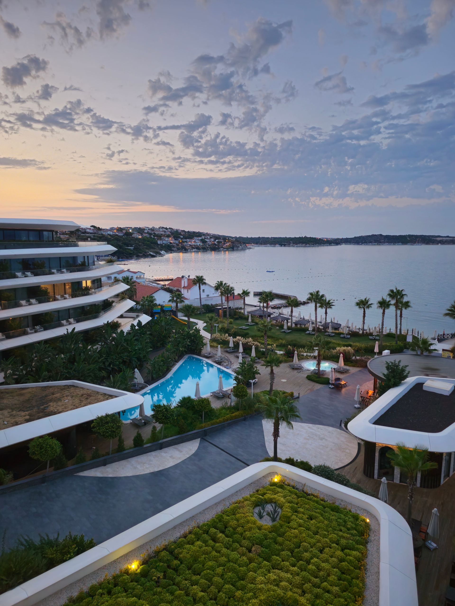The house at dusk, terraces facing the bay